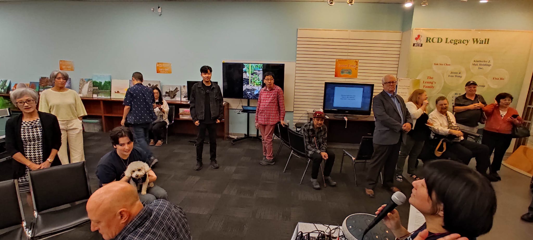 A photo of RCD Grand Opening in September 2024, with guests standing around the Activity Room, mingling and socializing 